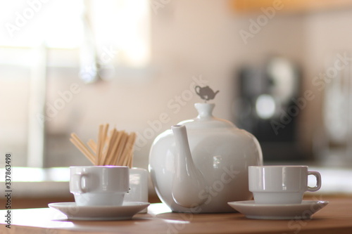 cup, tea, coffee, drink, white, teapot, table, beverage, breakfast, cafe, hot, mug, saucer, food, morning, spoon, espresso, restaurant, pot, kitchen, plate, tableware, brown, cups
