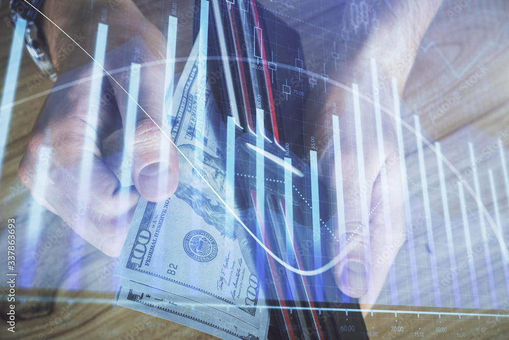 Obraz premium Multi exposure of forex graph drawing hologram and USA dollars bills and man hands. Technical Analysis concept.