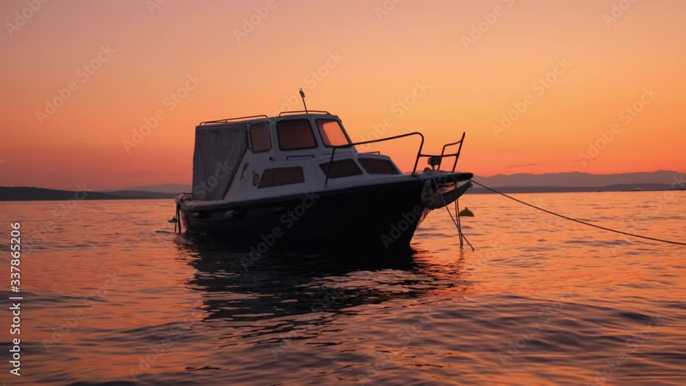 Slow motion shot: Sunset by the sea. Fishing boat sways in the waves. 4k. Slow motion Slow motion shot: Sunset by the sea. Fishing boat sways in the waves. 4k. Slow motion