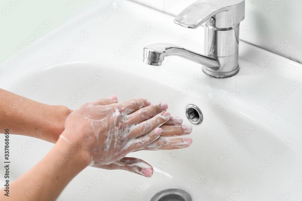 Woman washing hands with soap Woman washing hands with soap