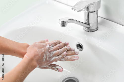 Woman washing hands with soap
