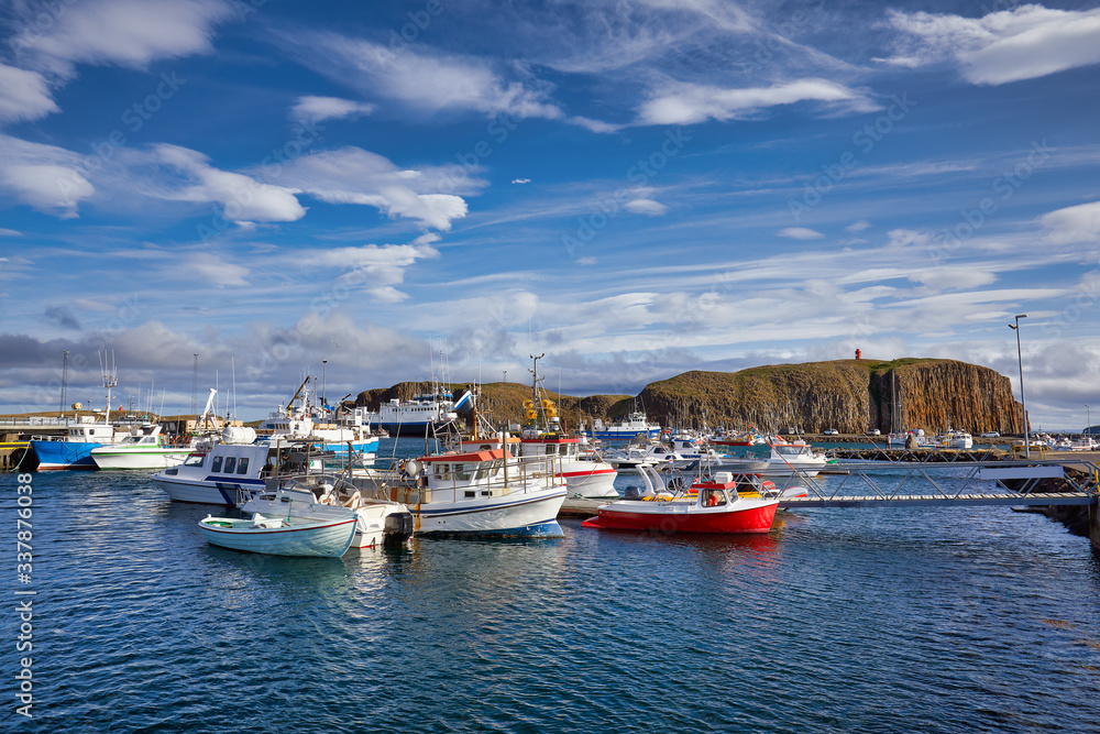 Beautiful panoramic view of the Stykkisholmskirkja Harbor with Fishing ships (boats) at Stykkisholmur town in western Iceland. City view from Sugandisey Cliff with lighthouse. Famous colorful houses