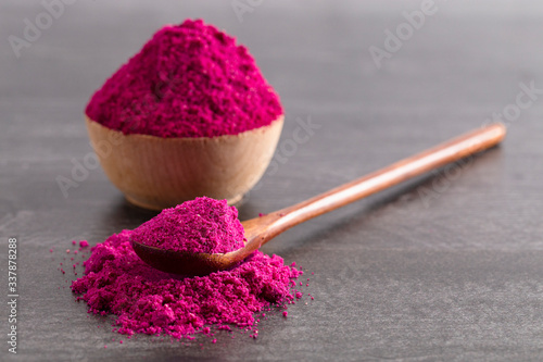 Pink Dragonfruit Powder on a Black Wooden Counter photo