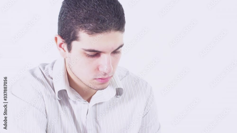 A contract or waiver is passed to a young man in a white sterile room