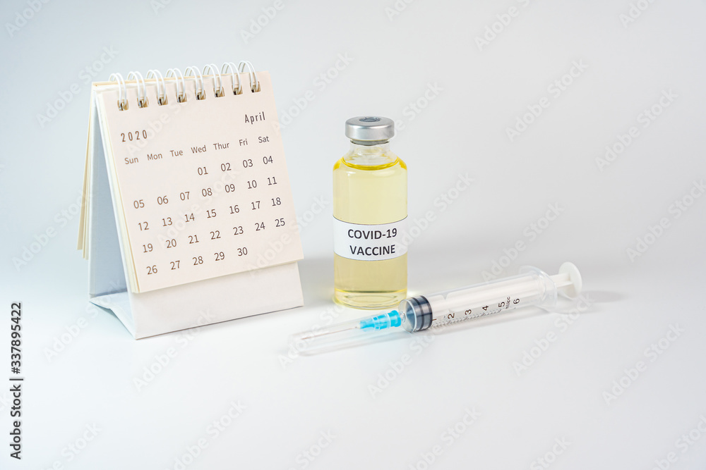 Studio shot of Covid-19 vaccine bottle and 2020 calendar 
