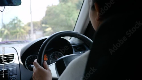 Wallpaper Mural Young woman driving a car, hand put on the black steering wheel and looking forward drive with caution. Torontodigital.ca