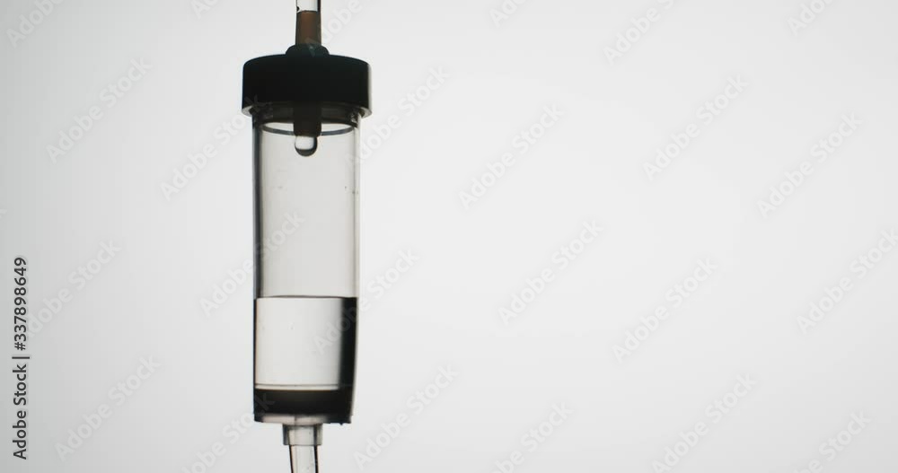 Macro shot: Dropper. Liquid or saline slowly dripping in left corner of frame. Dripping Injection Dropper. 4k. 60fps Macro shot: Dropper. Liquid or saline slowly dripping in left corner of frame. Dripping Injection Dropper. 4k. 60fps