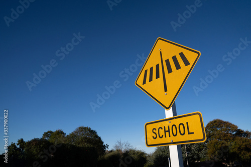 School crosswalk sign with blue sky.