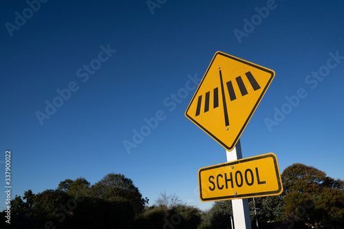 School crosswalk sign with blue sky. photo