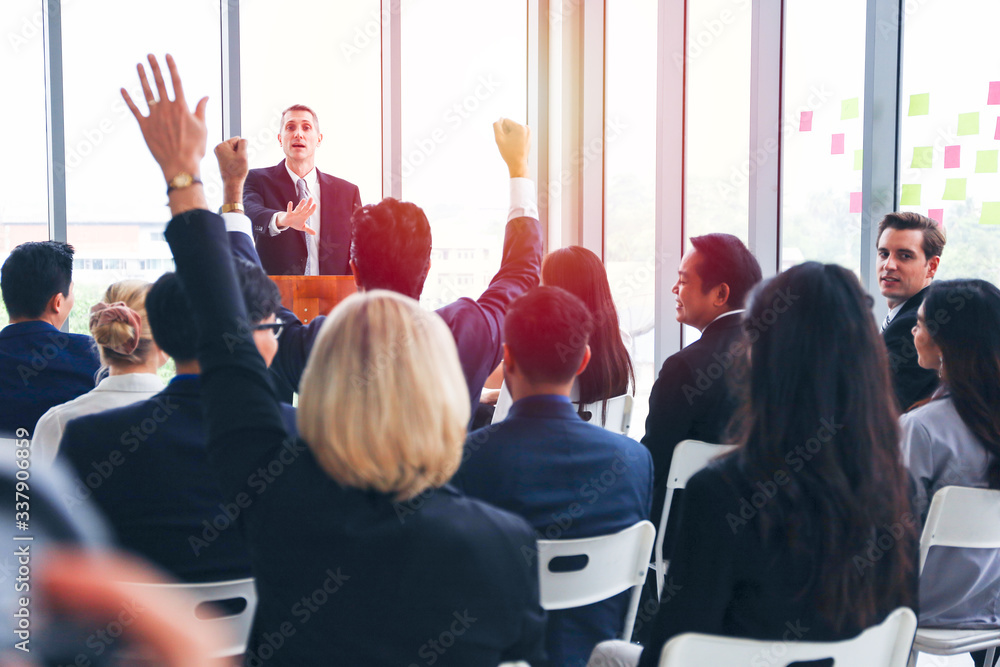 Fototapeta premium Group of business people or employees meeting or seminar in office hall, executive or professional smart speaker speaking on podium 