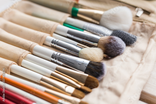Makeup, beauty and cosmetics concept - Set of make-up brushes in a light case.