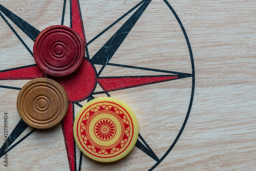 Carom board with striker and carom men. Selective focus. photo