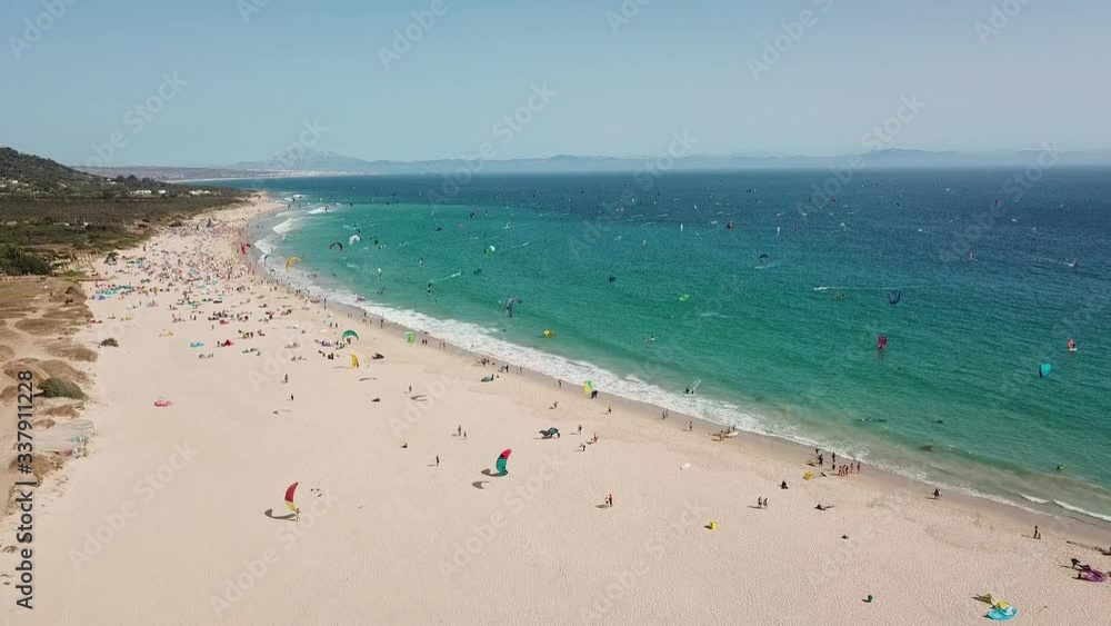 Kite-surfer and Windsurfer beautiful cinematic aerial view at very popular location Valdevaquero Beach, Punta Paloma, Tarifa , Cadiz Spain. Very popular location for wind sport in south west of Spain.