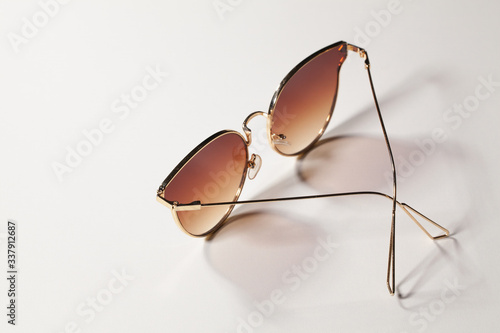 Golden women sunglasses isolated on the white background.