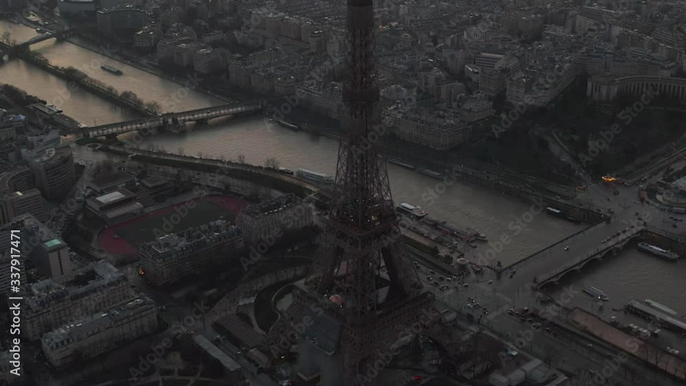 AERIAL: Drone Slowly Circling Eiffel Tower, Tour Eiffel in Paris, France with view on Seine River in Beautiful Sunset Light AERIAL: Drone Slowly Circling Eiffel Tower, Tour Eiffel in Paris, France with view on Seine River in Beautiful Sunset Light