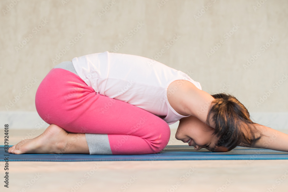 calmness and relax, female freedom happiness. home practice room background. little asian girl meditates while practicing yoga. child happiness. toned picture healthy life. yoga concept. calmness and relax, female freedom happiness. home practice room background. little asian girl meditates while practicing yoga. child happiness. toned picture healthy life. yoga concept.