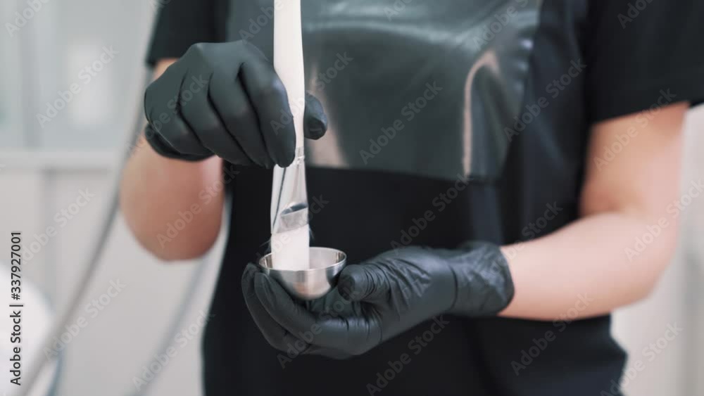Hands of an unidentified cosmetologist stir a cosmetic emulsion Hands of an unidentified cosmetologist stir a cosmetic emulsion