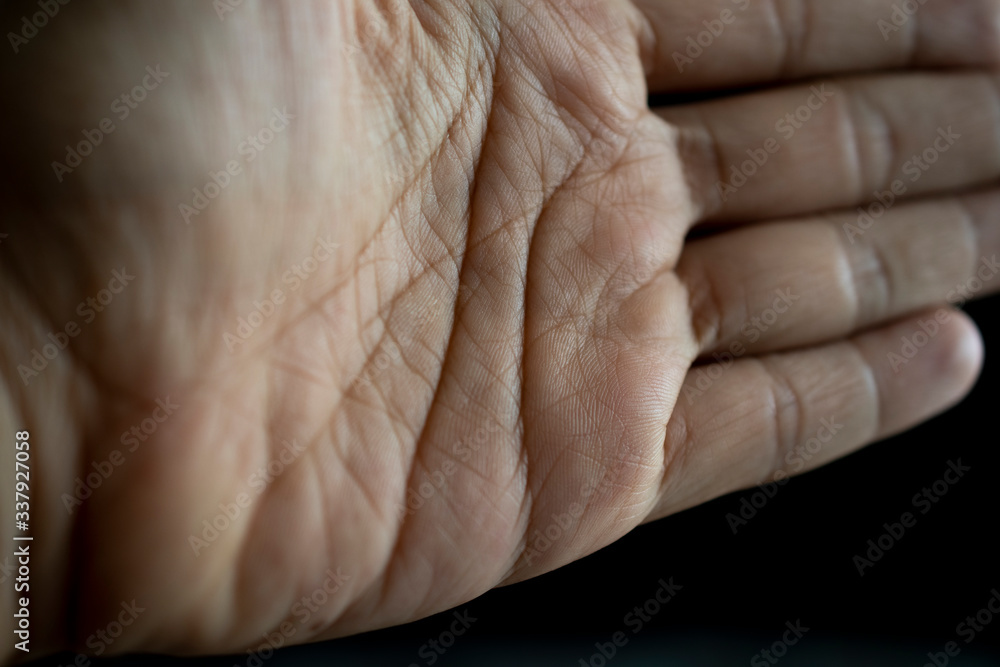 Fototapeta premium People hand closeup shot on the black background,