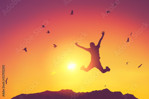 Silhouette man jump and birds fly on sunset sky and cloud texture abstract background. © tonktiti
