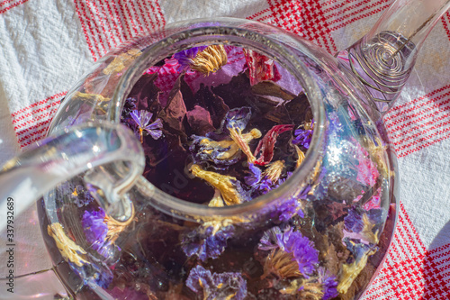 Close-up of a glass teapot with brewed flower tea inside