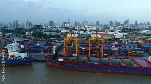 Aerial view of cargo ship, cargo container in warehouse harbor at thailand, container ship in import export and business logistic with sunset