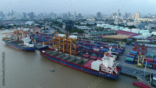 Aerial view of cargo ship, cargo container in warehouse harbor at thailand, container ship in import export and business logistic with sunset