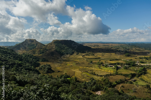 amazing landscape in the countryside with a stream flowing by and a vista view of the clouds and the mountains photo