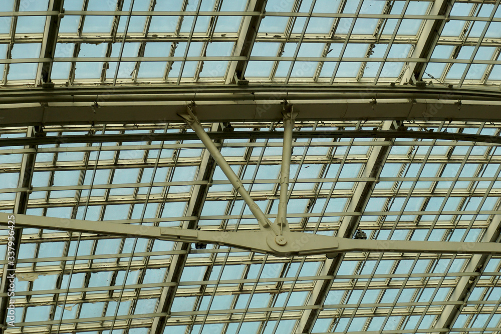     Metal construction supporting a glass roof.