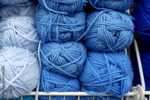  Balls of blue yarn on the shelves of the store.