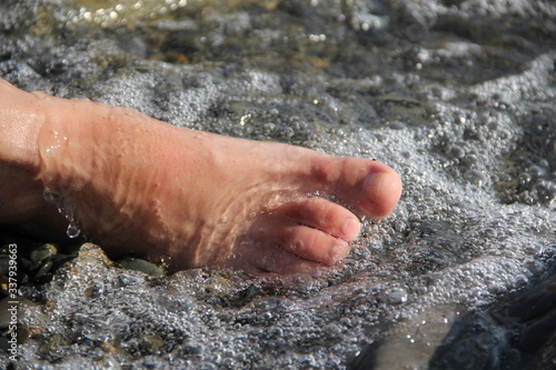 Women's foot on the beach
