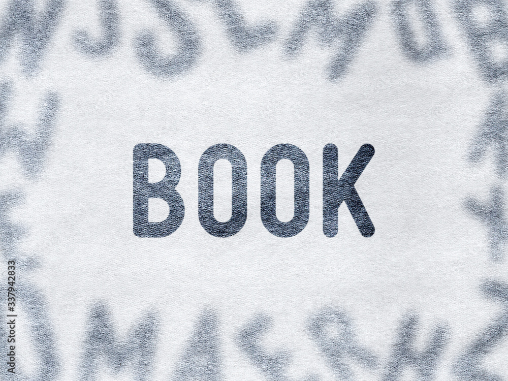 BOOK - Word on paper surrounded by blurry letters BOOK - Word on paper surrounded by blurry letters