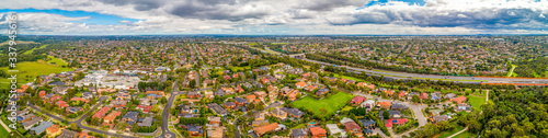 Wide aerial panorama of Mulgrave suburb and Eastlink highway on overcast day in Melbourne, Australia