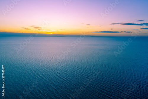 Beautiful sunset over calm water with copy space - aerial landscape