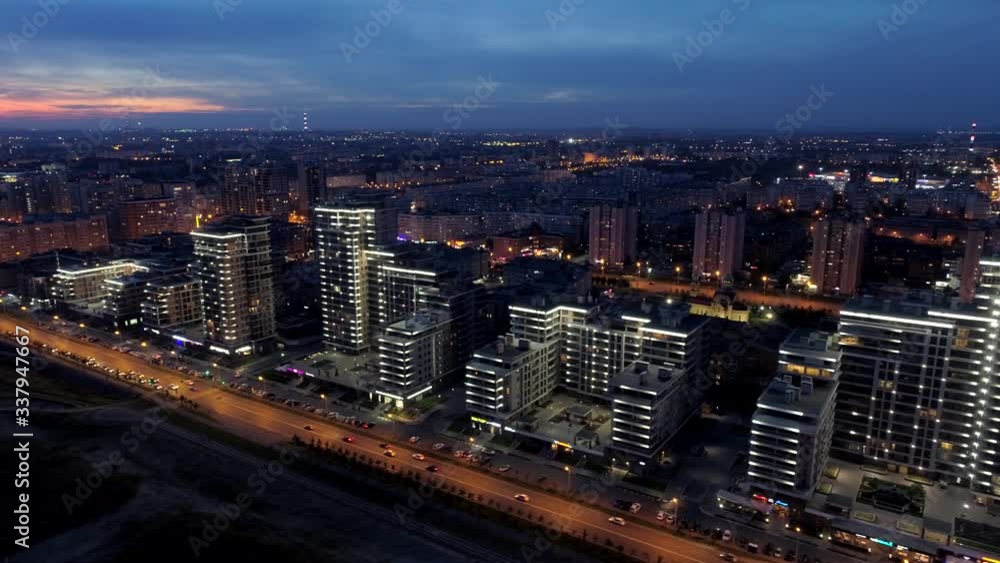 From great height epic Kazan night cityscape backlight skyline. City center modern quarter downtown area. Promenade. Road traffic network. Cinematic clouds. Beautiful sunset horizon. Aerial flight From great height epic Kazan night cityscape backlight skyline. City center modern quarter downtown area. Promenade. Road traffic network. Cinematic clouds. Beautiful sunset horizon. Aerial flight