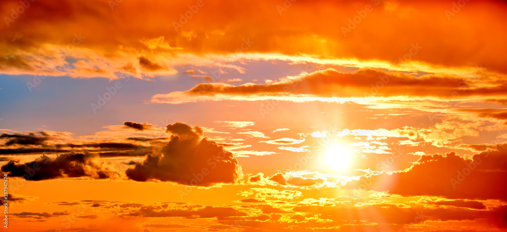 cloudy sunset sky landscape background natural color of evening cloudscape panorama with setting sun and clouds wide panoramic view Orange sunlight of evening nature