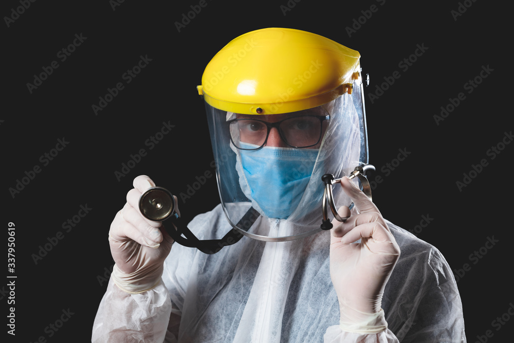 Medical doctor, nurse, surgeon, psychologist working with protective mask, glasses and gloves helping people in the days of panic, pandemic - studio shot on black background. Medical doctor, nurse, surgeon, psychologist working with protective mask, glasses and gloves helping people in the days of panic, pandemic - studio shot on black background.