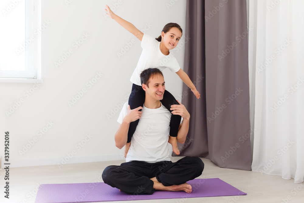 Father and daughter doing yoga at home Father and daughter doing yoga at home