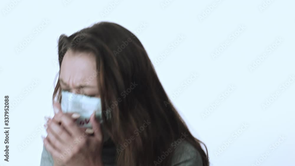 Young beautiful infected girl on white background coughs. Covid-19 virus spread Young beautiful infected girl on white background coughs. Covid-19 virus spread