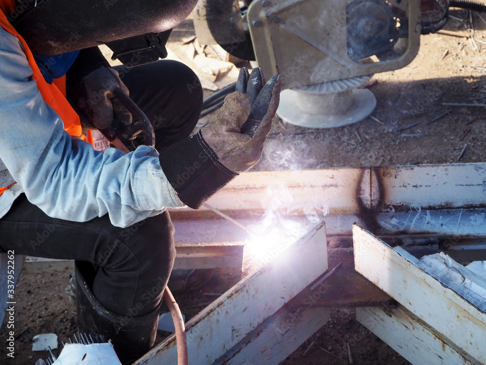Welding work ,worker with protective welding metal on construction Welding work ,worker with protective welding metal on construction