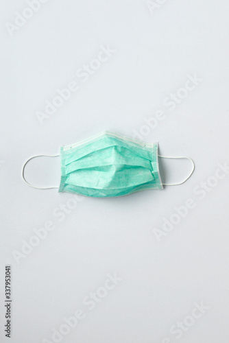 Still life of a green face mask on white background