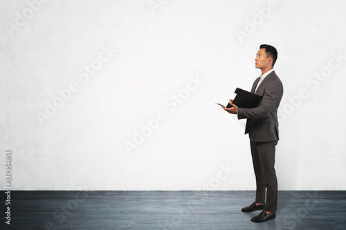 Confident businessman with clipboard, mock up