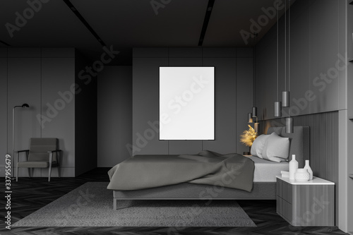 Gray bedroom with vertical poster and armchair