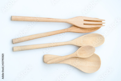 wooden spoon and fork on pastel color background