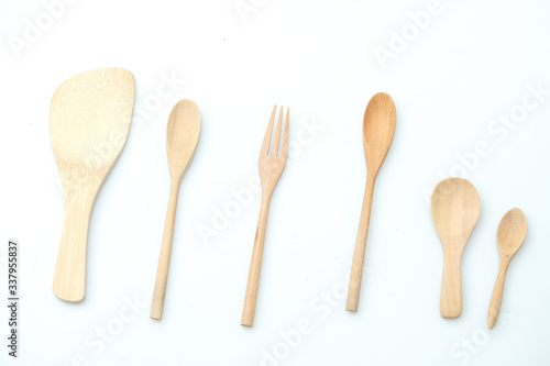 wooden spoon and fork on pastel color background © panyawatt
