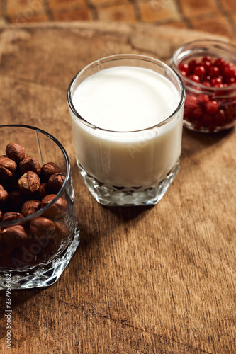 Yogurt with nuts on a wooden light background. Natural yogurt.