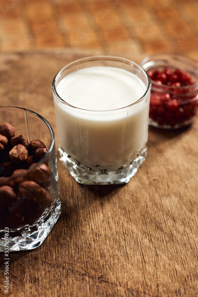 Yogurt with nuts on a wooden light background. Natural yogurt. Yogurt with nuts on a wooden light background. Natural yogurt.