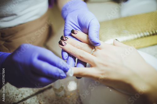 Manicure process in beauty salon, close up.