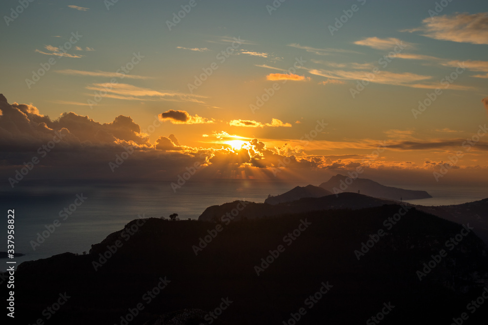the promontory of the Sorrento peninsula and the island of capri in the background at sunset, Campania, Italy