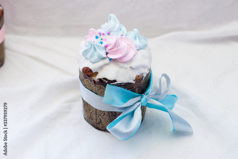Traditional orthodox easter cake kulich with festive blue and pink decoration. White background, lot of copy space. Traditional orthodox easter cake kulich with festive blue and pink decoration. White background, lot of copy space.