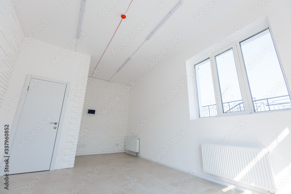 Office extension that uses bricks as a wall, construction, improvement. Interior of small room with window and bricks walls renovation, extension, overhaul and reconstruction. Office extension that uses bricks as a wall, construction, improvement. Interior of small room with window and bricks walls renovation, extension, overhaul and reconstruction.